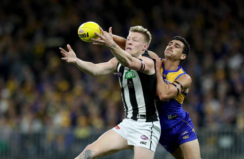 Tom Cole punches the ball clear of Jordan De Goey in the qualifying final.