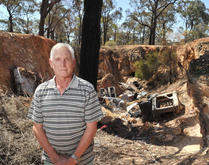 DUMPING GROUND: Norm Gray with some of the rubbish in the Whipstick State Park. Picture: NONI HYETT