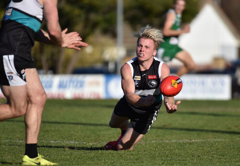 QUICK HANDS: Maryborough midfielder Coby Perry fires out a handball in the Magpies' win over Kangaroo Flat at Dower Park on Saturday. Picture: GLENN DANIELS