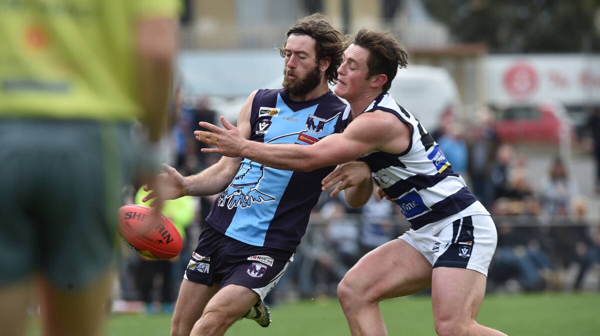 Eaglehawk's Jesse Collins gets a kick clear ahead of the Storm's Trent Donnan.