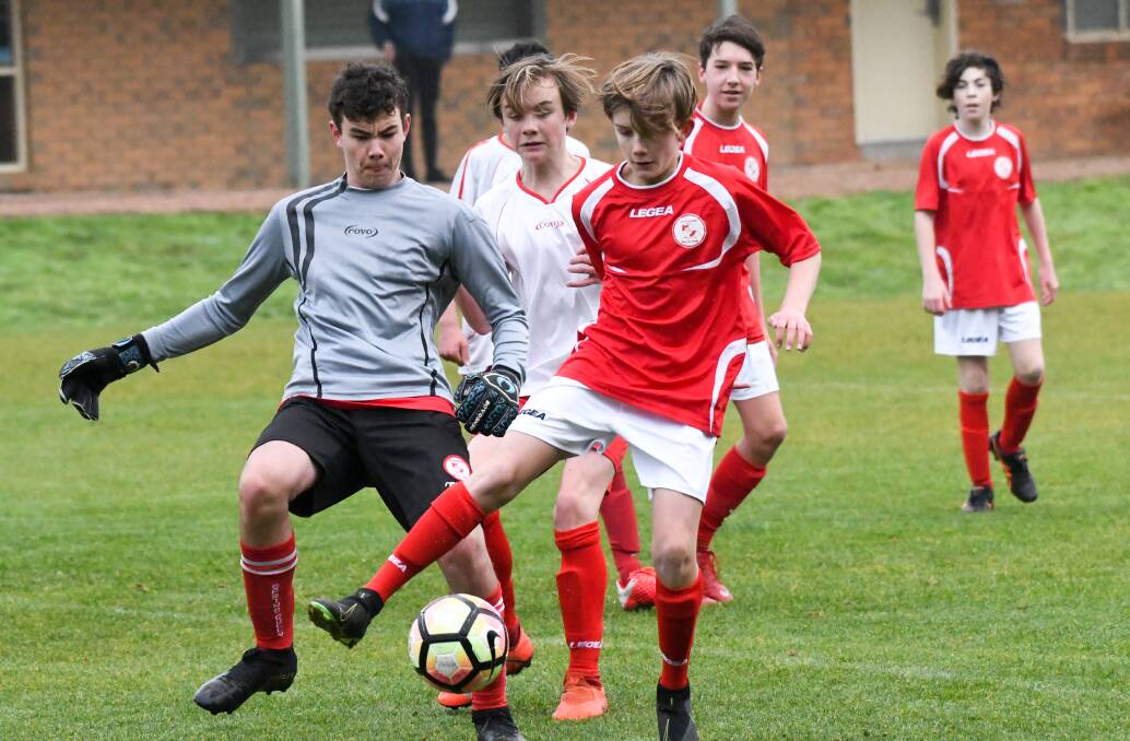 Action from the under-14 clash between Spring Gully White and Spring Gully Red City. Picture: NONI HYETT