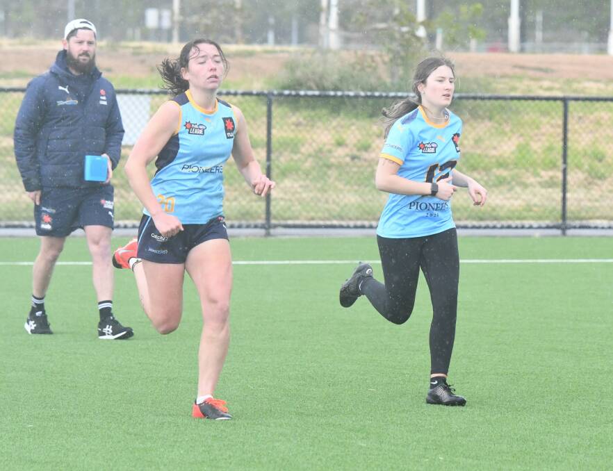 HARD WORK: Scarlett Orritt and Molly Pianta during the Beep Test at Pioneers' training. Picture: ADAM BOURKE