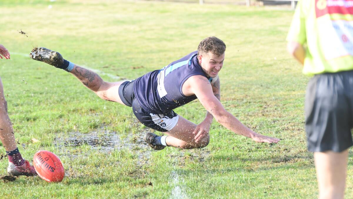 Eaglehawk's Noah Wheeler tries to keep the ball in play on the soggy outer wing at Canterbury Park. Picture: ANTHONY PINDA