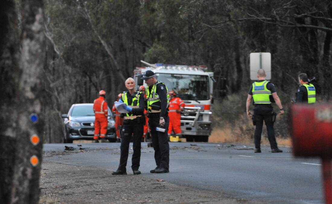 Police officers and SES crew at the scene of a fatal crash in Maiden Gully on Sunday night.
