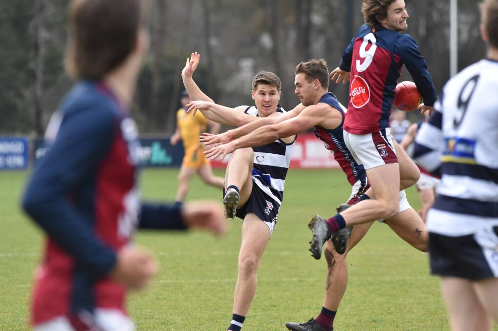 Lachlan Gill has a snap for goal smothered by the Sandhurst defence. Picture: NONI HYETT