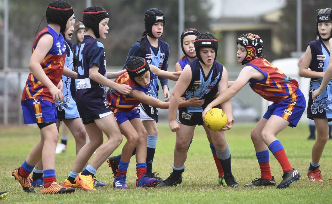 Eaglehawk and Marong under-12 players battle for the ball in their clash at California Gully on Saturday. Picture: BRENDAN McCARTHY