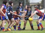 Eaglehawk and Marong under-12 players battle for the ball in their clash at California Gully on Saturday. Picture: BRENDAN McCARTHY