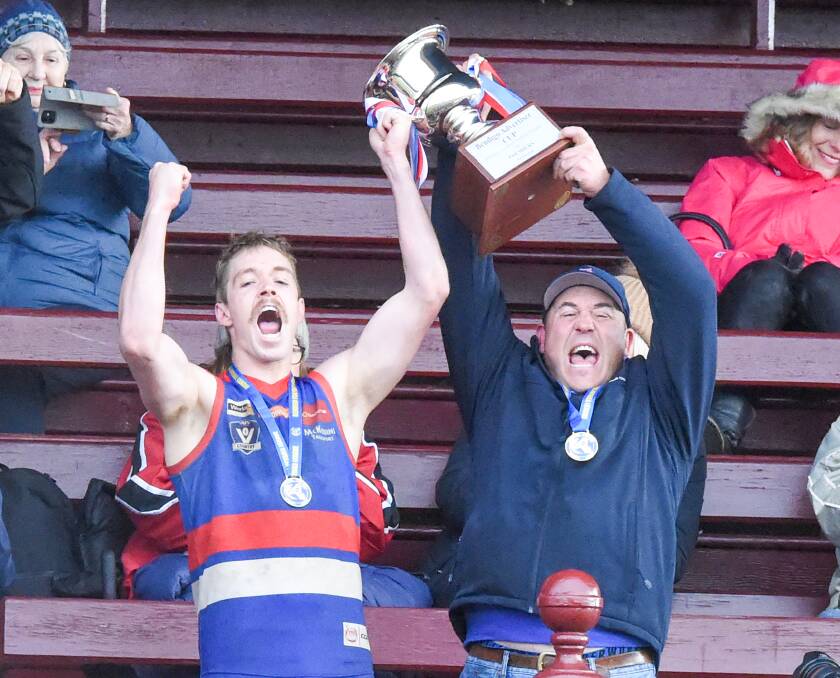 Gisborne captain Pat McKenna and coach Rob Waters raise the Bendigo Advertiser Premiership Cup. Picture by Darren Howe