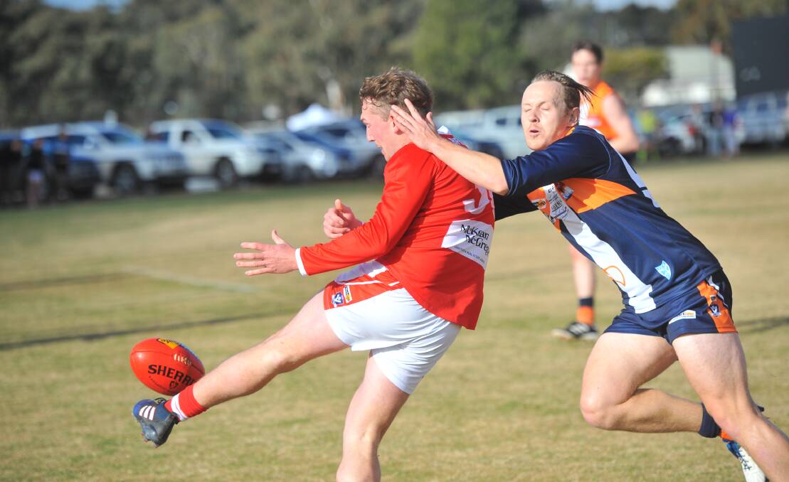 Bridgewater's Matt Bourke gets his kick away despite the attention from Maiden Gully YCW's Max Grant. Picture: ADAM BOURKE