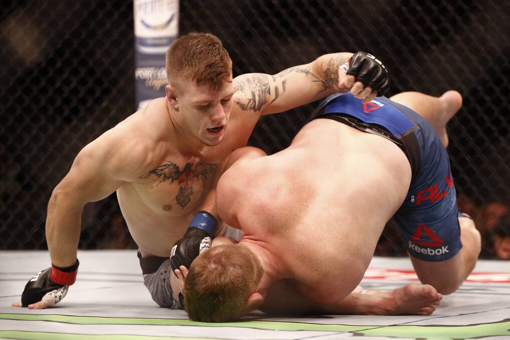 Jimmy Crute, left, puts the pressure on Sam Alvey in Sunday's UFC bout. Picture: AAP