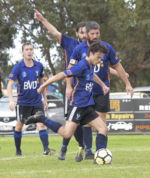 TEAMWORK: Eaglehawk defenders clear the ball in Sunday's win over Golden City. Pictures: NONI HYETT