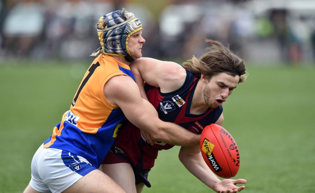 Lachlan Ross does battle with Clayton Anderson in the 2016 BFNL grand final.