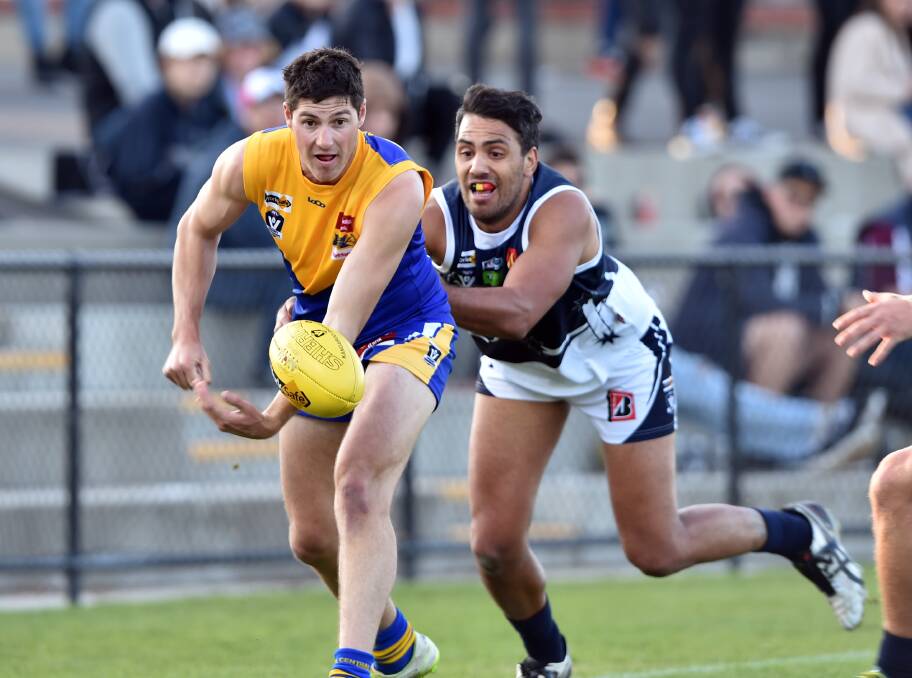 The BFNL is back on home turf for the 2019 AFL Victoria Community Championships. BFNL's Brenton Conforti fires out a handball against Ballarat in 2017 at the QEO. Picture: GLENN DANIELS