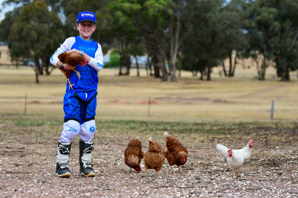 Nate Hargreaves with his chooks at his family property in Marong. Picture by Enzo Tomasiello