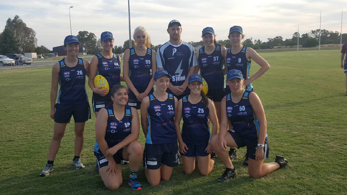 Strathfieldsaye's Lachlan Sharp with some of the Pioneers' under-18 girls squad. Picture: CONTRIBUTED