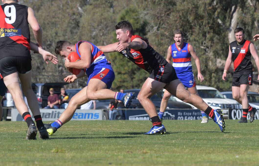 Jack Gleeson attempts to tackle Manny Thalasinos in the HDFNL second semi-final. Picture: NONI HYETT