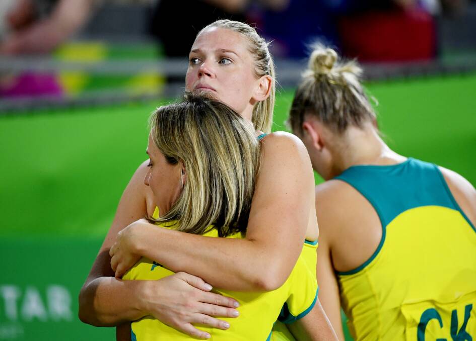 Bendigo's Caitlin Thwaites hugs the Australian team physio after the Diamonds' shock defeat in the gold medal game.