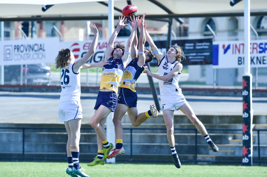 PACK FLIES: The Bendigo Pioneers and Geelong Falcons compete in the air for the ball. Pictures: DARREN HOWE