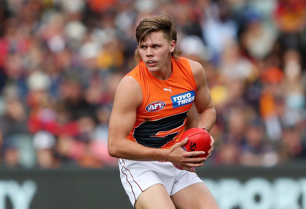Cooper Hamitlon wins the ball for one of his 12 possessions in his first AFL game for the GWS Giants. Picture: GETTY IMAGES