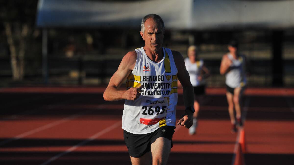 CRUISING: Mike Bieleny crosses the finish line to win the Jack Davey 5000m Championship. Picture: ADAM BOURKE