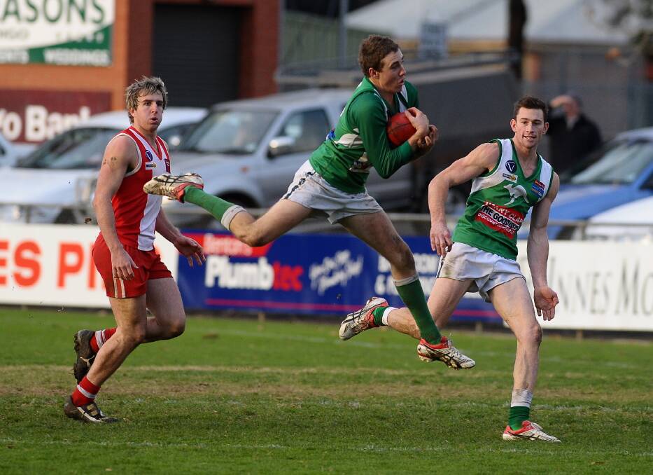 Tyrone Downie marks in front of team-mate Justin Maddern and South Bendigo's Michael Leach.