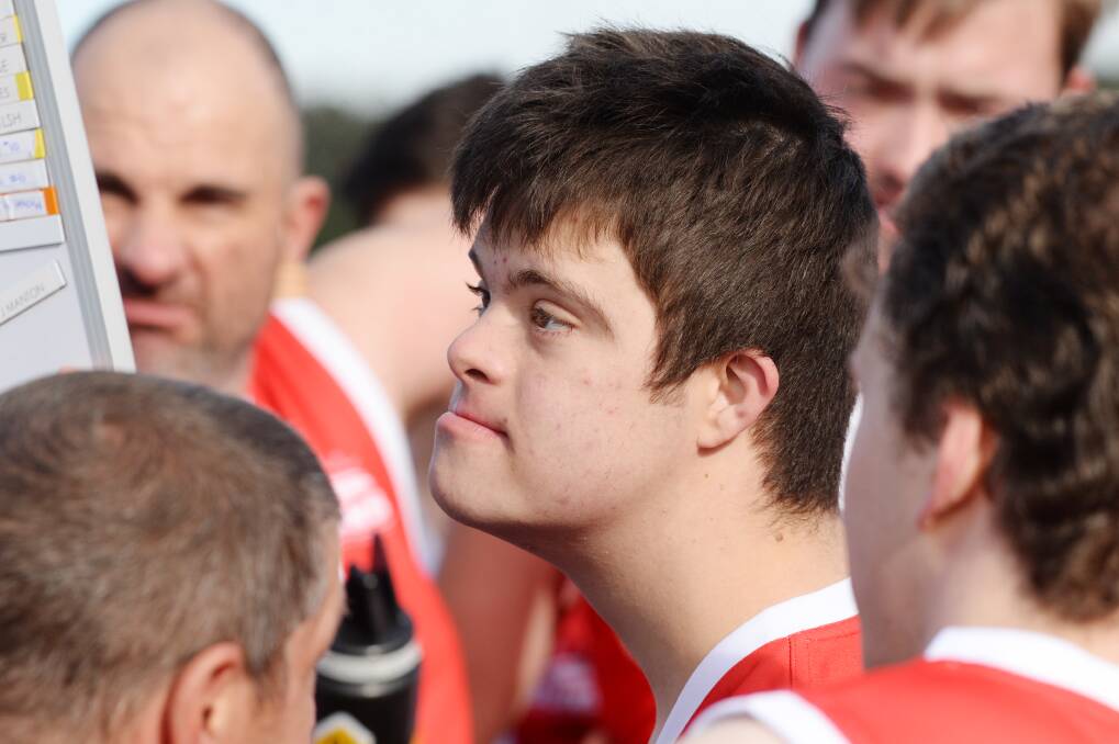 TEAM PLAYER: Jesse Martin listens intently to the half-time talk.
