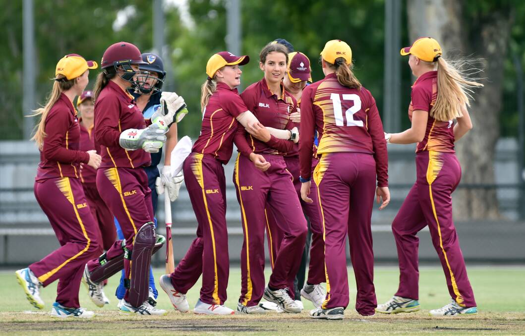 Queensland players celebrate a crucial wicket in Friday night's T20 grand final win over ACT/NSW Country. Picture: GLENN DANIELS