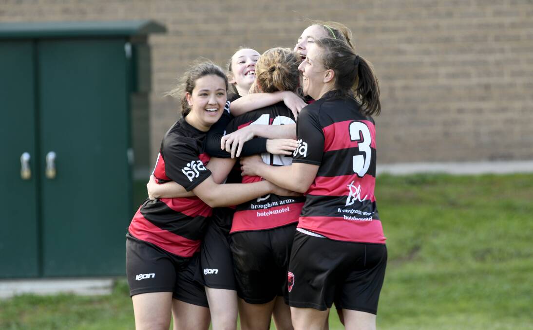  WE DID IT: La Trobe University players celebrate their winning goal against Strathdale on home turf on Sunday.