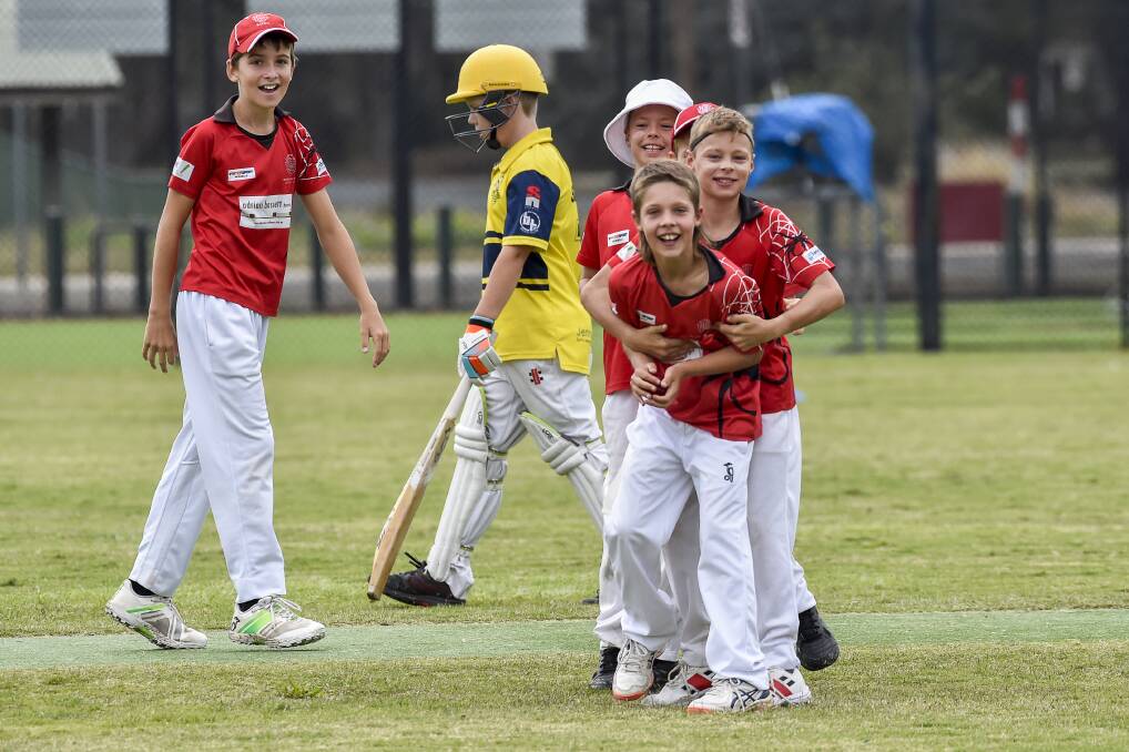MEDIA STREET: Fletcher Stevenson and team-mates complete their wicket celebration by smiling for the Bendigo Addy camera. Pictures: DARREN HOWE
