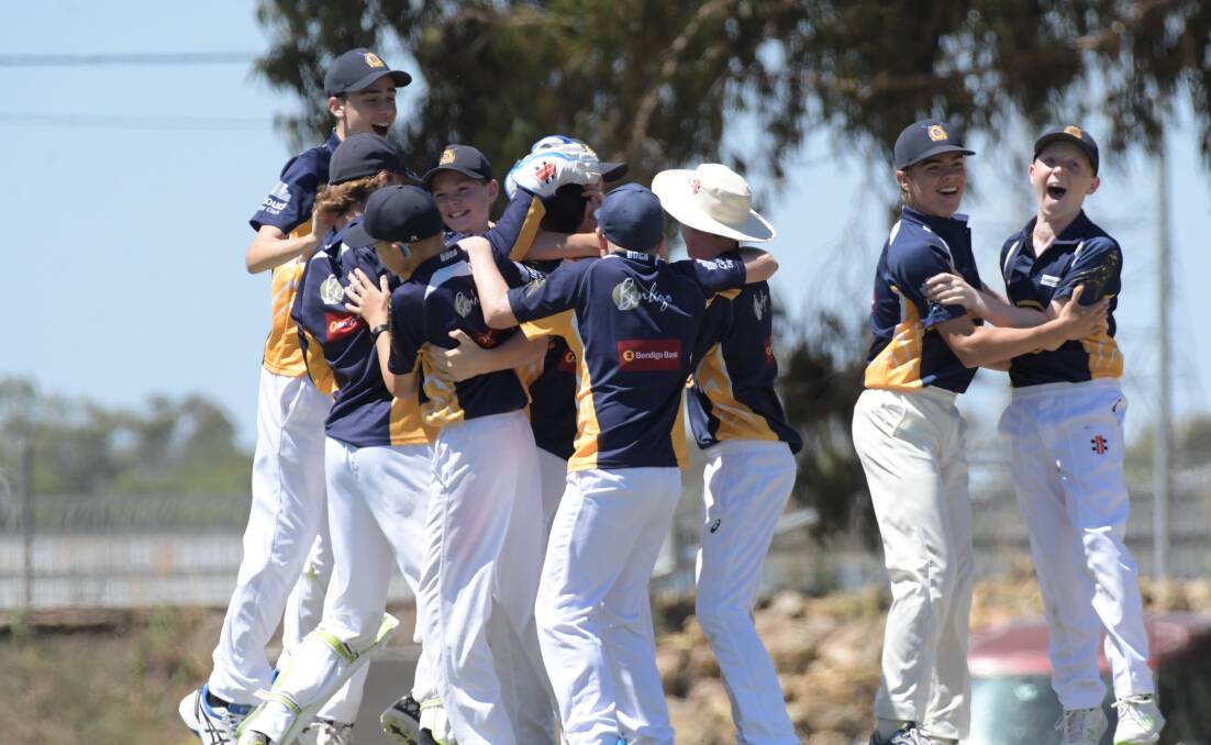 The Bendigo under-14 players embrace after they took the final wicket to secure a one-run win over Shepparton. Picture: NONI HYETT