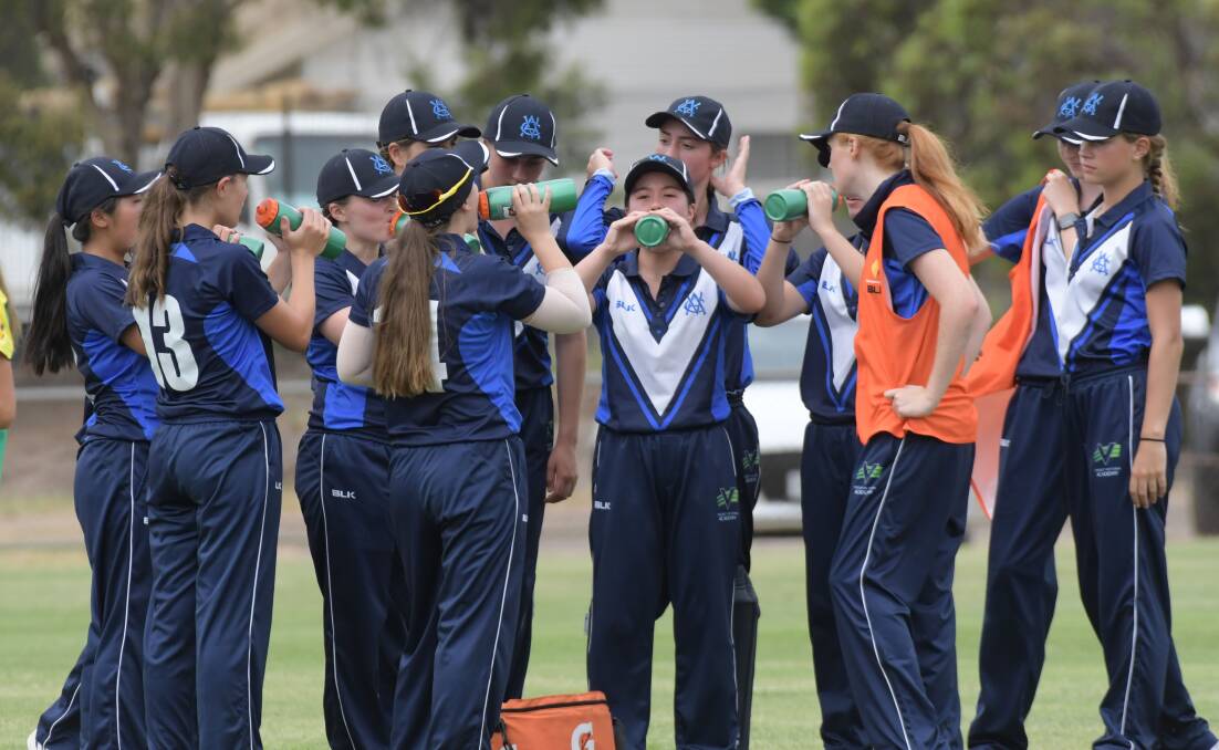 THIRSTY WORK: The Vic Metro players enjoy a drink. Picture: NONI HYETT