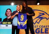 AFL Draft number one pick Harley Reid receives his first West Coast Eagles jumper from club great Nic Naitanui. Picture by Getty Images