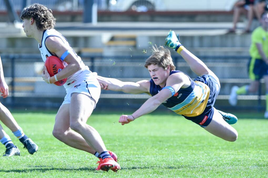 DESPERATE: Bendigo Pioneers' Sam Conforti lunges for a tackle in Sunday's loss to the Geelong Falcons at the QEO. Picture: DARREN HOWE