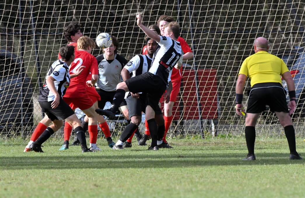 SCRAMBLE: Spring Gully and Shepparton South players battle for the ball in front of goal. Pictures: NONI HYETT