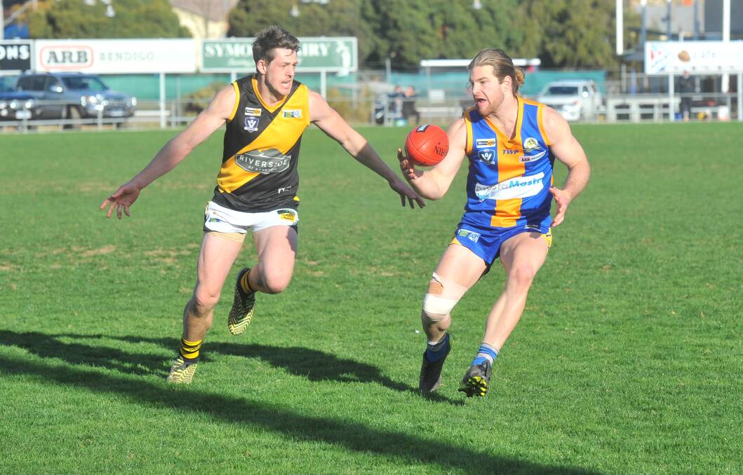ONE-ON-ONE: Kyneton's Harrison Huntley moves in to tackle Golden Square's Jordan Rosengren at Wade Street on Saturday. Picture: ADAM BOURKE