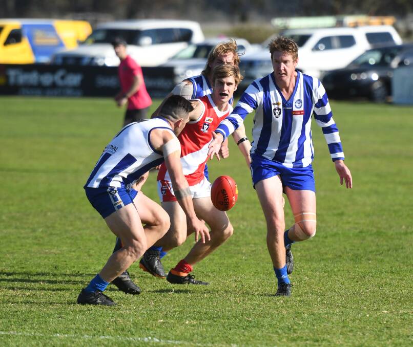 BALL MAGNET: Mitiamo's Dougie Thomas picks up the ball ahead of team-mate Lachlan Woodward.
