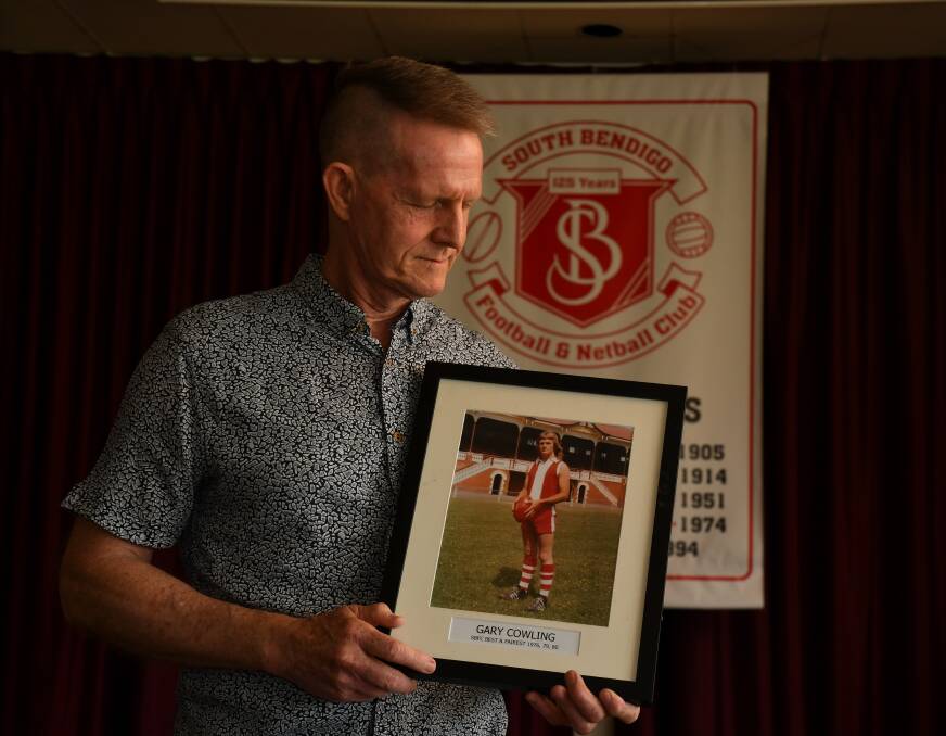 PROUD: Shane Cowling with a photo of his brother Gary in the South Bendigo Football Netball Club social rooms. Picture: NONI HYETT 