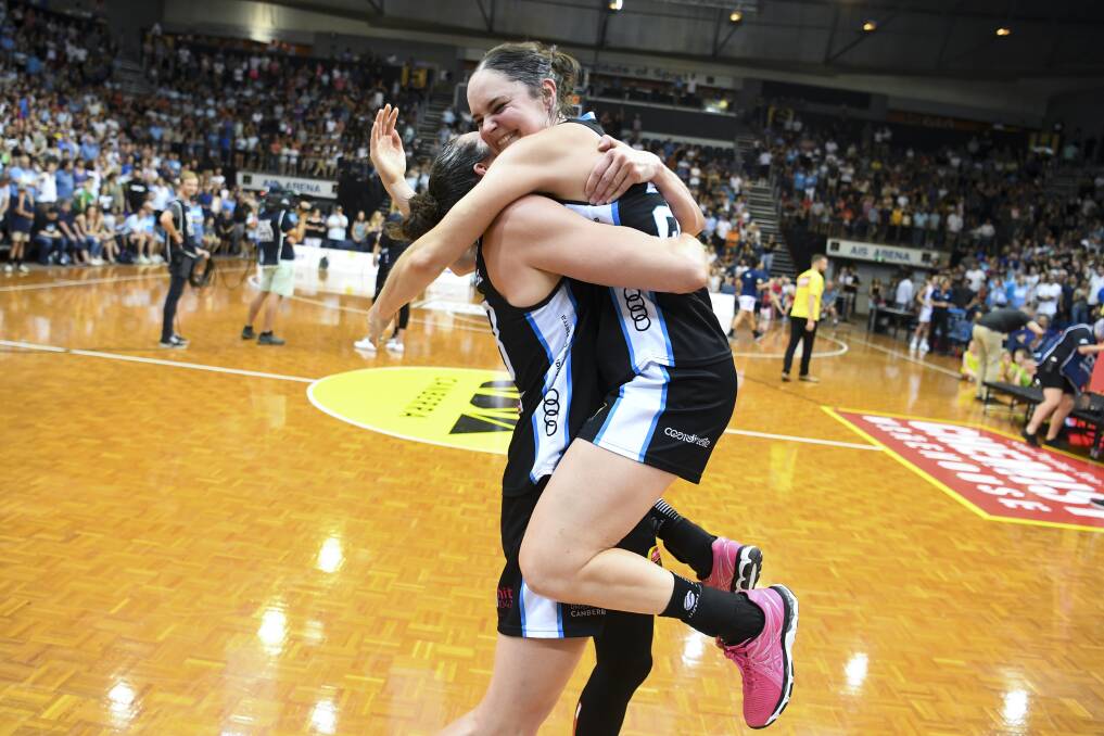 Kelsey Griffin and Kelly Wilson embrace after the University of Canberra Capitals won the WNBL championship.