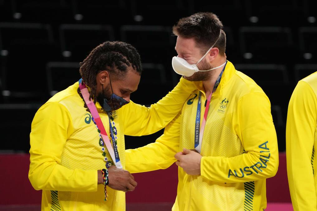 BROTHERS IN BRONZE: Patty Mills and Matthew Dellavedova after receiving their Olympic bronze medals. Picture: AAP