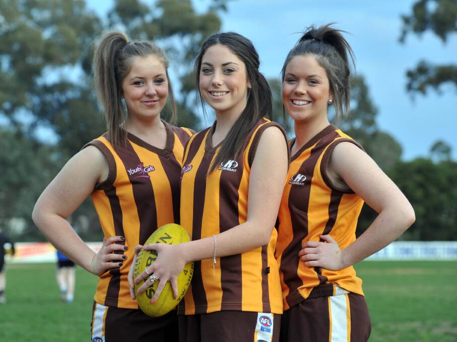 Sisters Lily, Ruby and Grace Campbell with Huntly Football Club in 2011.