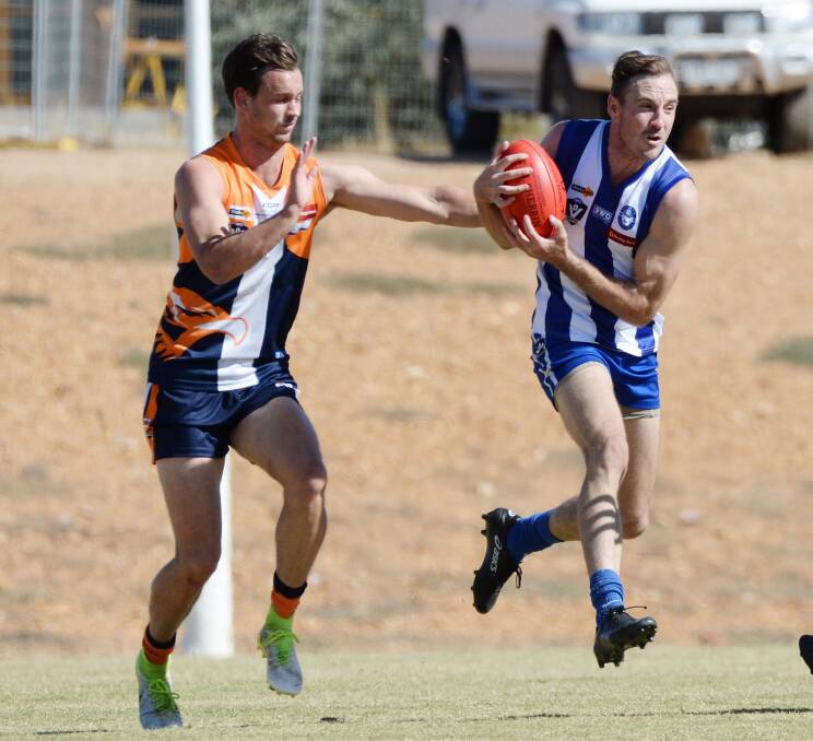 ON THE CHEST: Mitiamo co-coach Tyroen Downie marks in front of Maiden Gully YCW defender Alex Pearson. Pictures: DARREN HOWE
