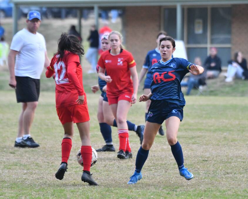 FC Eaglehawk's Emily Pengelly tries to blast past Spring Gully's Leila Bartolo. Picture by Adam Bourke
