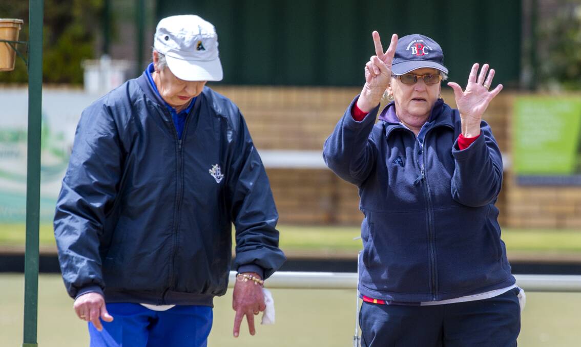 Golden Square's Mardi Chisholm and Bendigo's Judy Adams deliver the score to team-mates in Monday's midweek pennant clash. Picture: DARREN HOWE