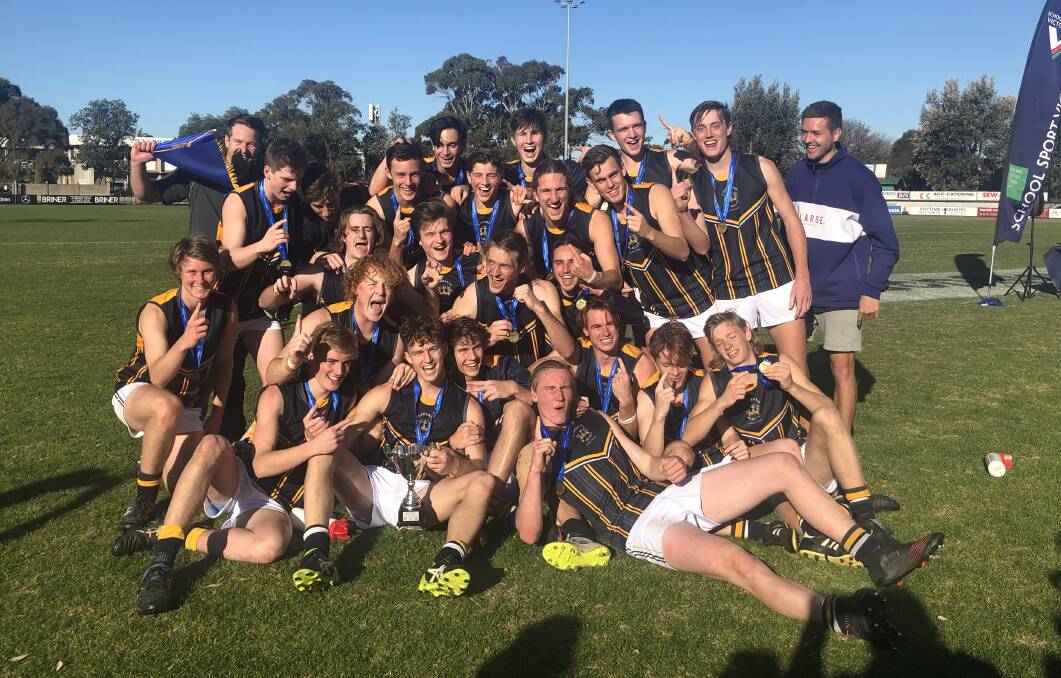 CMC players and coaches celebrate their grand final win over Essendon-Keilor College. Picture: MAREE PEARCE