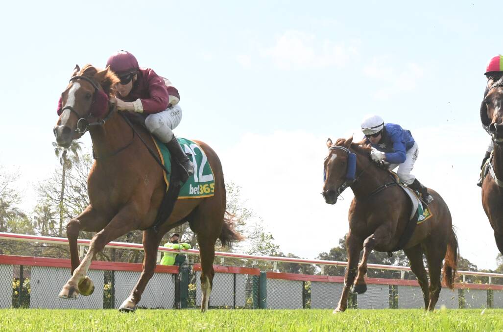 Red Cracker cruises down the outside to win on home soil on Saturday. Picture: RACING PHOTOS
