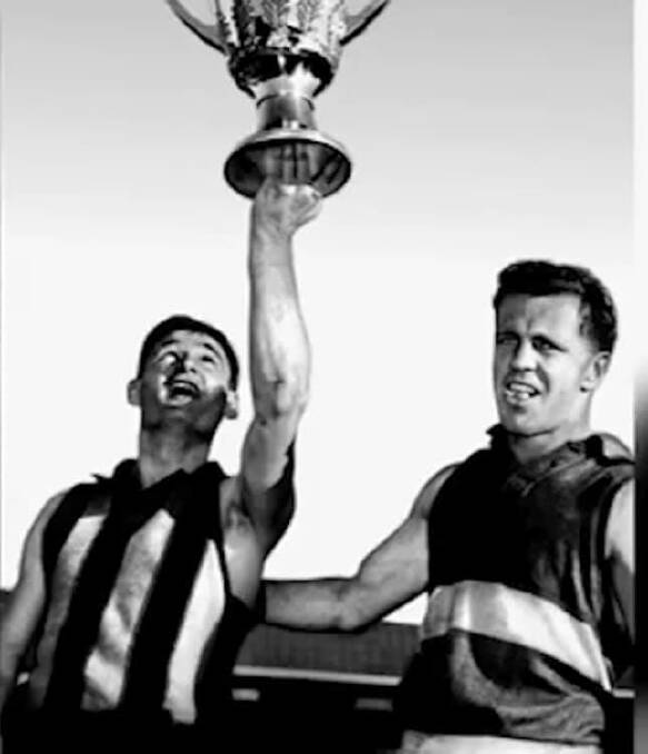 FLASHBACK: Graham Arthur lifts the premiership cup after Hawthorn's 1961 grand final triumph. Ted Whitten was the Footscray captain.