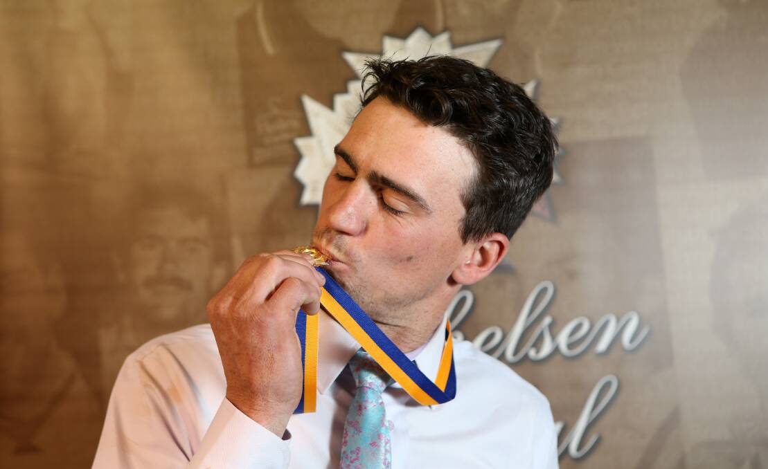 Adam Baird gives his Michelsen Medal a kiss. Picture: GLENN DANIELS