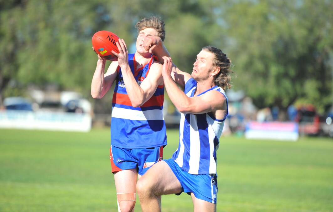 Pyramid Hill's Bailey George tries to mark the ball in front of Mitiamo's Jarryd Wiegard. Picture: ADAM BOURKE