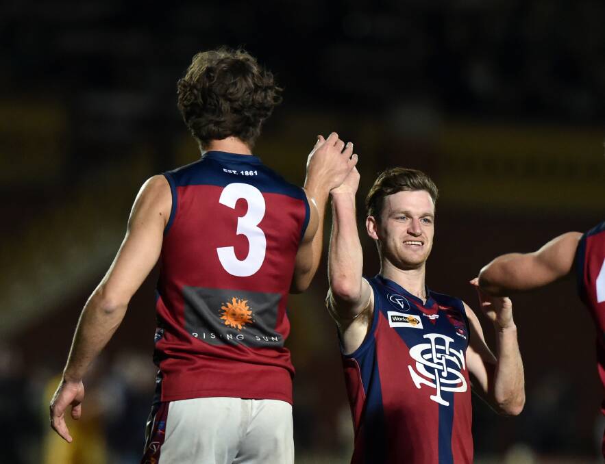 THE ODD COUPLE: Matt Thornton (3) and Nick Stagg exchange a high five after a Sandhurst goal in last year's preliminary final.