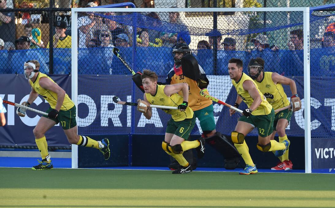 The Kookaburras' defence scrambles to defend a penalty corner against India. Picture: NONI HYETT